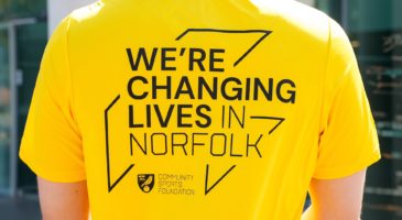 back of tshirt saying we're changing lives in norfolk