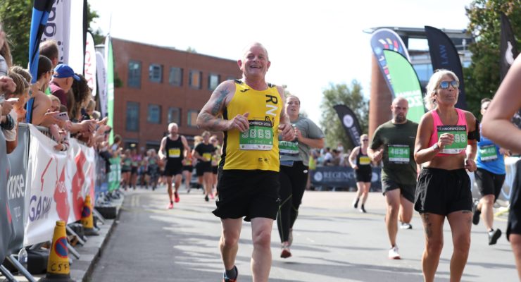 man in yellow top running