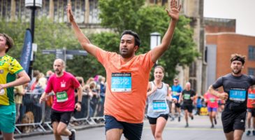 Run Norwich finisher celebrates with hands in the air