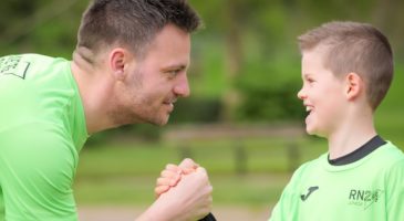 Man and boy arm wrestling