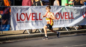boy running past lovell banner