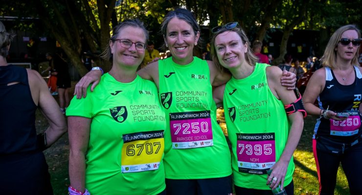three women in green running tops
