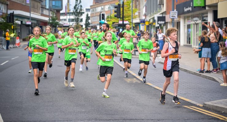 children in green tshirts running