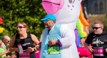 man in unicorn costume running