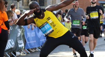 man in yellow top pulling a pose