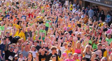 crowd of runners looking up at camera