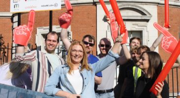 group of people waving in support