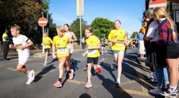 children running in yellow tshirts